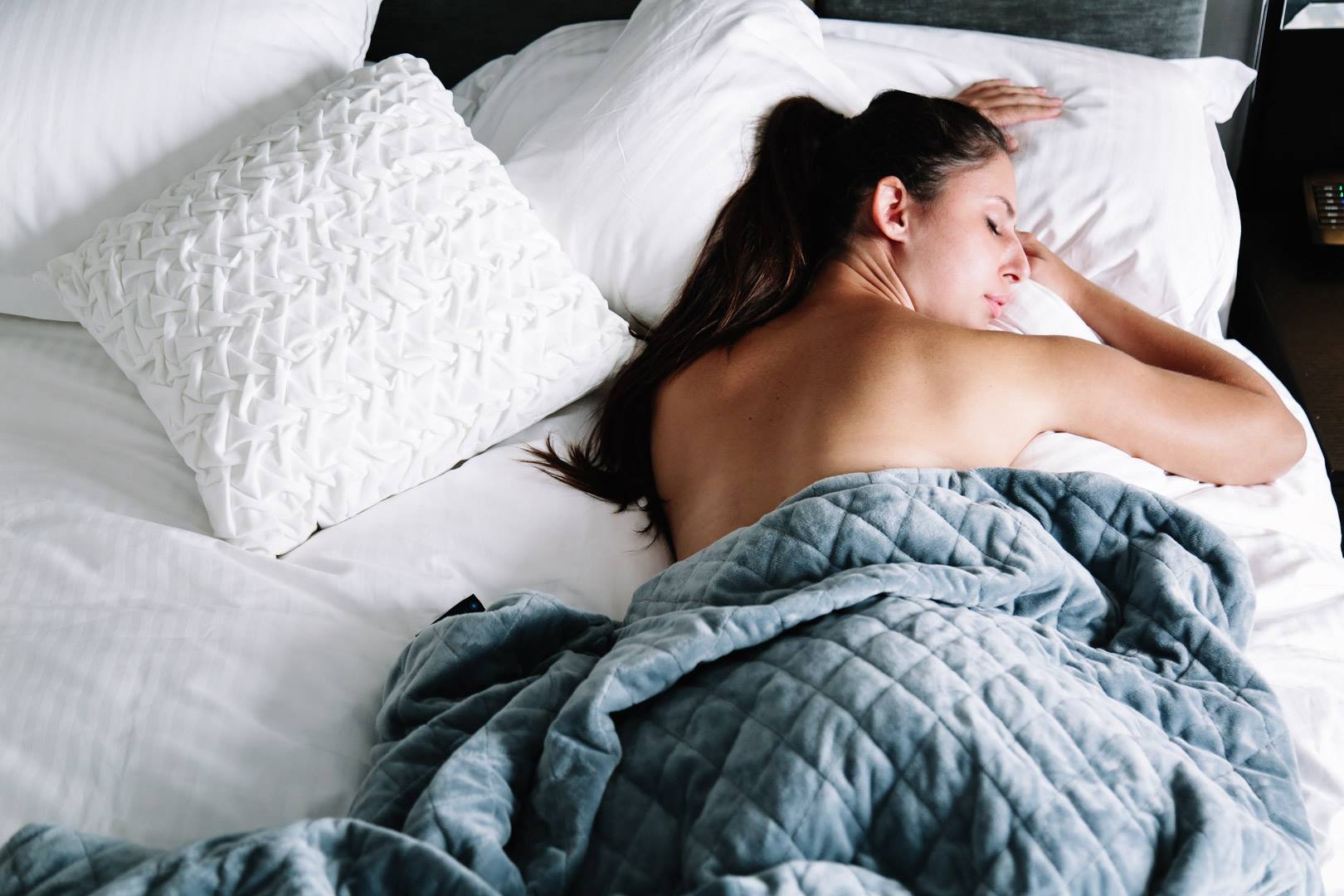 woman sleeping with neptune weighted blanket