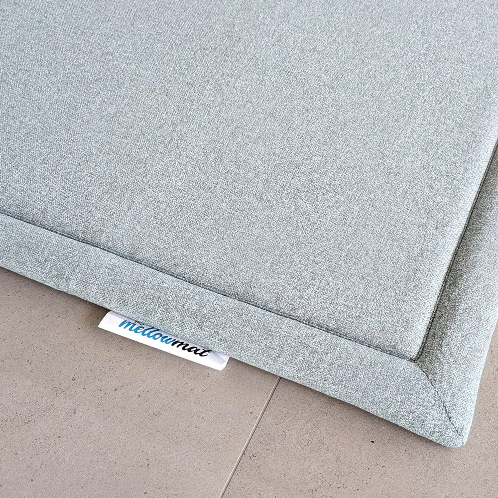 Close-up of a gray mat corner with a 'mellowmat' label.